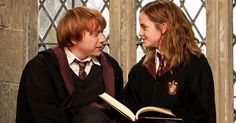 two young people dressed in harry potter outfits, one reading a book and the other looking at each other