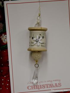 a christmas card with a birdhouse hanging from it's side on a string