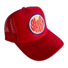 a red trucker hat with the word shine on it