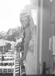 the bride and groom are posing for a photo on their wedding day in black and white