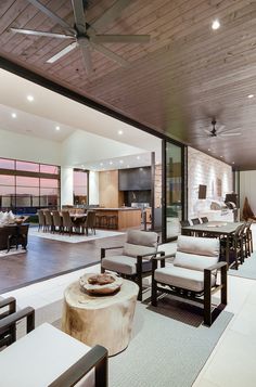 a living room filled with furniture and a large open kitchen area next to a dining table