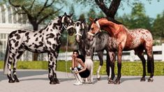 three horses standing next to each other in front of a white building and two women