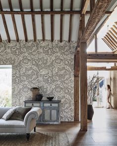 a living room filled with furniture and walls covered in wallpaper