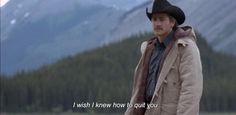 a man wearing a cowboy hat standing in front of mountains with a quote written on it