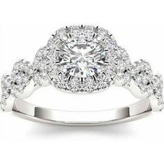 a white gold engagement ring with round diamonds on the band and an oval halo setting