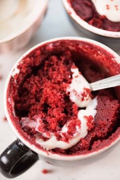 two cups filled with red velvet and whipped cream