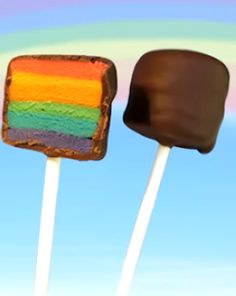 there are two pops that have been made to look like the same rainbow cake on them