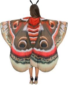 a woman wearing a butterfly shaped shawl with her back turned to the camera,