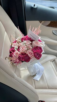 a bouquet of flowers sitting in the back seat of a car