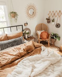 an unmade bed in a bedroom with lots of pillows and blankets on top of it