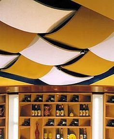 a room filled with lots of shelves covered in yellow and white umbrellas