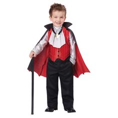 a little boy dressed in a dracula costume