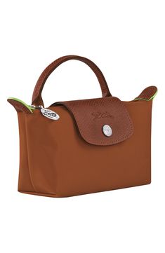 Textured leather trim adds a signature finishing touch to this durable nylon case that's perfectly proportioned for securing your cosmetics while on the go. Water-resistant lining Textile with leather trim Imported Longchamp Le Pliage Green, Recycled Canvas, Stylish Bag, Cosmetic Case, Supply Chain, Longchamp Le Pliage, Leather Trim, Leather Trims, Cognac