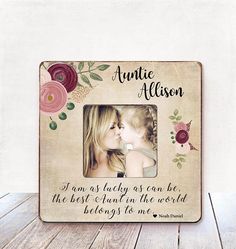 a wooden frame with an image of a mother and daughter kissing each other on the cheek