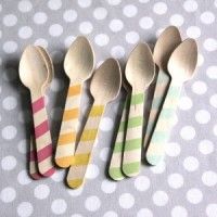 five wooden spoons lined up next to each other on a polka dot tablecloth