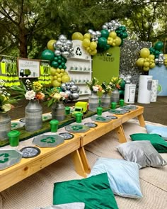 a long table with green and white decorations on the top is set up for a st patrick's day party