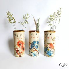 three ceramic vases with plants in them