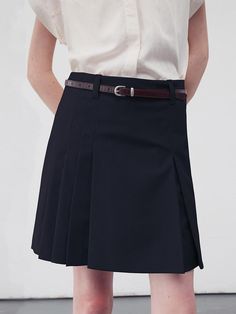 This product is a pleated mini skirt that marries classic schoolgirl charm with a modern edge. The skirt's tailored waistband and sharp pleats create a structured silhouette, while the mini length offers a playful twist. A discreet side zipper ensures a smooth fit, and the included belt with a unique buckle adds a fashionable detail. - The skirt's design ensures it sits comfortably at the waist, flattering a variety of body types.- Its pleats are crisply defined, maintaining the skirt's shape and adding movement.- The fabric choice offers a balance of durability and comfort, suitable for different occasions.- This pleated mini skirt can be styled in multiple ways, from pairing with a blouse and blazer for a smart look to wearing it with a relaxed tee for a casual outfit. Dark Academia Skirt, Pleated Mini Skirts, Navy Mini Skirt, Skirt Design, Pleated Mini Skirt, Dark Academia, Casual Outfit, Body Types, Side Zipper