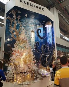 people looking at a display with an octopus in the center and other decorations on it