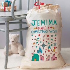 a white bag sitting on top of a table next to a teddy bear and chair