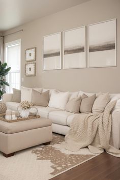 a living room filled with furniture and pictures on the wall