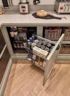 an open cabinet in a kitchen filled with food