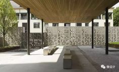 an outdoor covered area with benches and trees