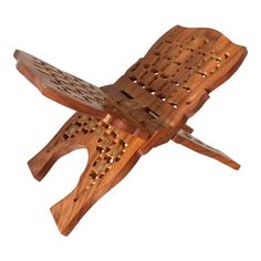 a wooden object with holes in it on a white background and one piece cut out to look like an airplane