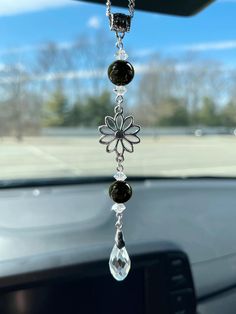 a car dashboard with a flower hanging from it's side