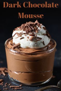 a chocolate mousse with whipped cream and chocolate shavings in the middle