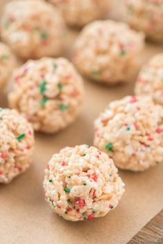 cookies with sprinkles are arranged on a sheet of brown paper and ready to be eaten