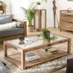 a living room filled with furniture and a coffee table on top of a rug covered floor