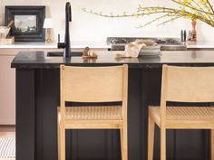 two wooden chairs sitting on top of a kitchen counter