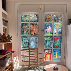 a room with two glass doors and a rocking chair in front of the door that has been painted