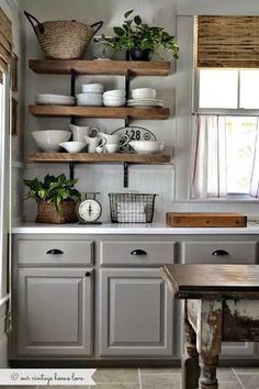 a kitchen filled with lots of open shelves