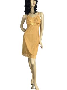 Vintage 60s slip dress in a rich gold shade with beautiful lace bodice. Nice details & a beautiful slip for autumn into the holiday season. Can easily be worn as a dress. - Quality gold nylon fabric - Satin floral applique at underbust - Floral lace bodice lined in sheer chiffon - Tiny lace trim at bodice - Scalloped floral lace trim - Satin straps with adjustable metal hardware - Made in USA LABEL: Seamprufe | 100% Antron Nylon CONDITION: Very Good to Excellent - one repair in side seam near hem done by previous owner (see last photo). Otherwise lovely. SIZE: tagged a 34 (bust) - Small - fits size 4/6 Bust - 33" Waist - 28" Hips - 36" Length - 37" Item # 2892 tags: vintage slip dress, fall fashion, gold slip dress, small vintage Gold Lace Dress With Lace Trim, Vintage Lace Slip Dress For Party, Vintage Lace Camisole Dress, Gold Dress With Lace Trim, Vintage Lace Trim Slip Dress For Party, Slip Dress Fall, Gold Slip Dress, Blue Slip Dress, Red Slip Dress