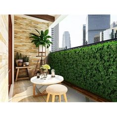 a balcony with a table and stools next to a wall covered in green plants