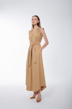 This dress is expertly tailored to provide the perfect silhouette. Its sleeveless design and flared cut highlight your curves and flatter your figure without compromising comfort. Crafted with quality raw fabric, this dress will ensure you look stylish with minimal hassle. Chic Sleeveless Maxi Dress For Work, Beige Sleeveless Midi Dress For Work, Chic Beige Maxi Length Sleeveless Dress, Elegant Beige V-neck Linen Dress, Luxury Beige Midi Dress With V-neck, Beige V-neck Dress In Rayon, Chic Beige V-neck Linen Dress, Beige Plain, Big Bow Dress