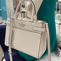 Kate Spade Staci Saffiano Leather Medium Satchel Crossbody Bag Parchment Color: Parchment White 100% Authentic 8.62"H X 10.87"W X 5"D Dual Rolled Leather Top Handle Drop: 5.5" Detachable And Adjustable Crossbody Leather Strap Drop: 22" Saffiano Leather Satchel With Zip Closure Signature Two Way Spade Jacquard Lining Ksny Metal Pinmount Logo Back Zip And Front Slip Pockets Front & Back Slip Pockets Brand New With Tag Kate Spade Satchel Handbags, Purses Medium Size, Kate Spade White Bag, Medium Sized Purses, White Kate Spade Purse, Medium Size Purse, Cute White Tote Bag, Cute Handbags Designer, Purses For School