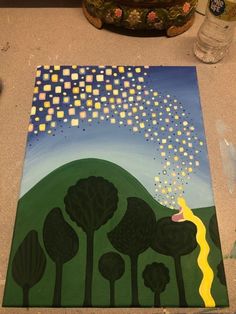 a painting on the ground with trees and stars coming out of it's sky