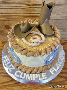 a cake with cowboy boots and rope on top