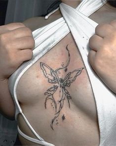 a woman's breast with a butterfly tattoo on it