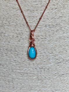 Turquoise and copper is such a beautiful combination, each color enhancing the other. This small, but boldly colored pendant shows off the copper/turquoise combo perfectly. This 10x14 natural turquoise oval cabochon is hand wrapped with bare copper wire. The pendant measures 1 3/8 inches in length (top of bail to bottom) and nearly 1/2 inch in width at the widest point of the pendant. Base wire is 20 gauge square wire and the smaller wrapping wire is 22 gauge half round wire. The pendant comes w Handmade Turquoise Copper Wire Necklace, Handmade Turquoise Necklace With Copper Wire, Turquoise Necklace With Copper Wire, Spiritual Electroformed Turquoise Jewelry, Unique Turquoise Copper Necklaces, Unique Turquoise Copper Necklace, Turquoise Copper Wire Necklace As Gift, Turquoise Copper Wire Necklace Gift, Turquoise Copper Wire Necklace For Gift