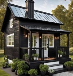 a small black house with white trim and windows