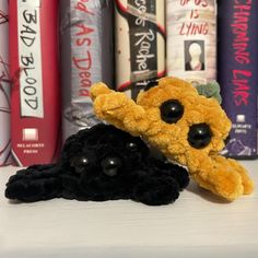 a stuffed animal laying on top of a book shelf next to bookshelves and other books