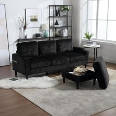 a living room filled with furniture and a white rug