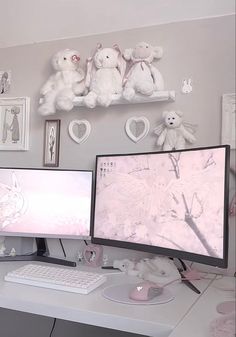 two computer monitors sitting on top of a white desk