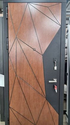 a wooden door with geometric designs on the front and side panels, in an office building