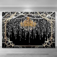 a chandelier hanging from the ceiling in front of a black and white wall