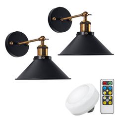 two black and gold wall lights next to a remote control for a light fixture with three different colors